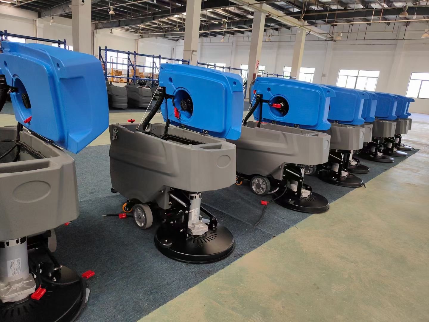 Floor scrubber tanks open during component fitting